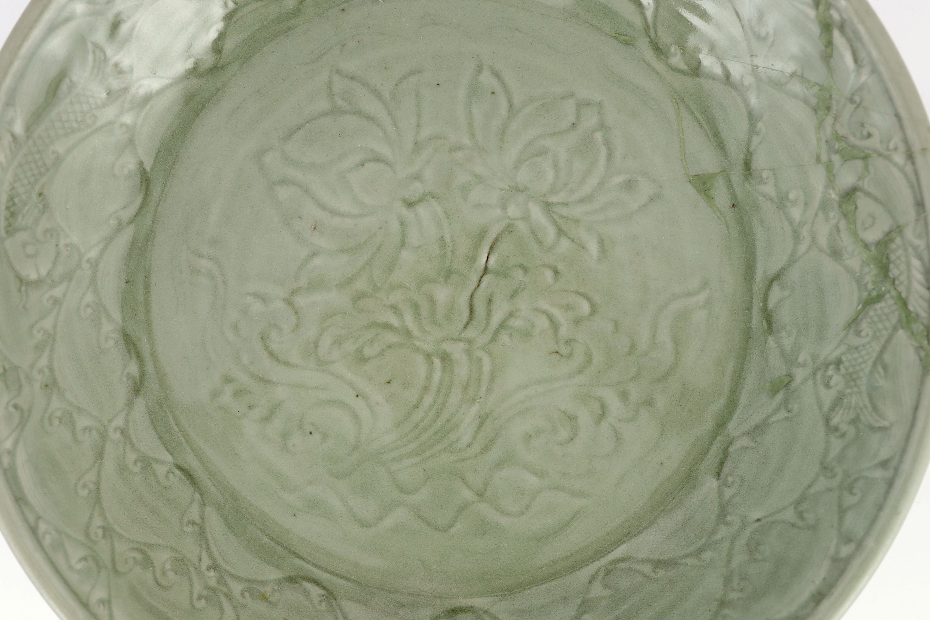 A rare large Chinese Ming Longquan celadon dish, 14th century, 44 cm diameter, Broken and restored